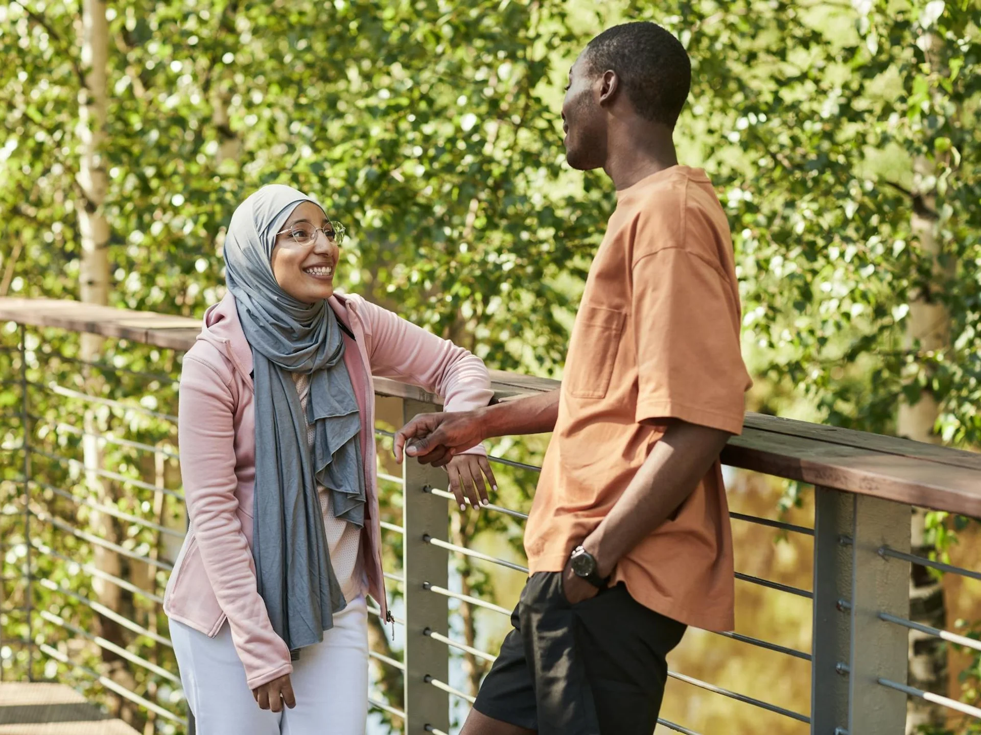Two friends enjoying a warm conversation outdoors on a sunny day