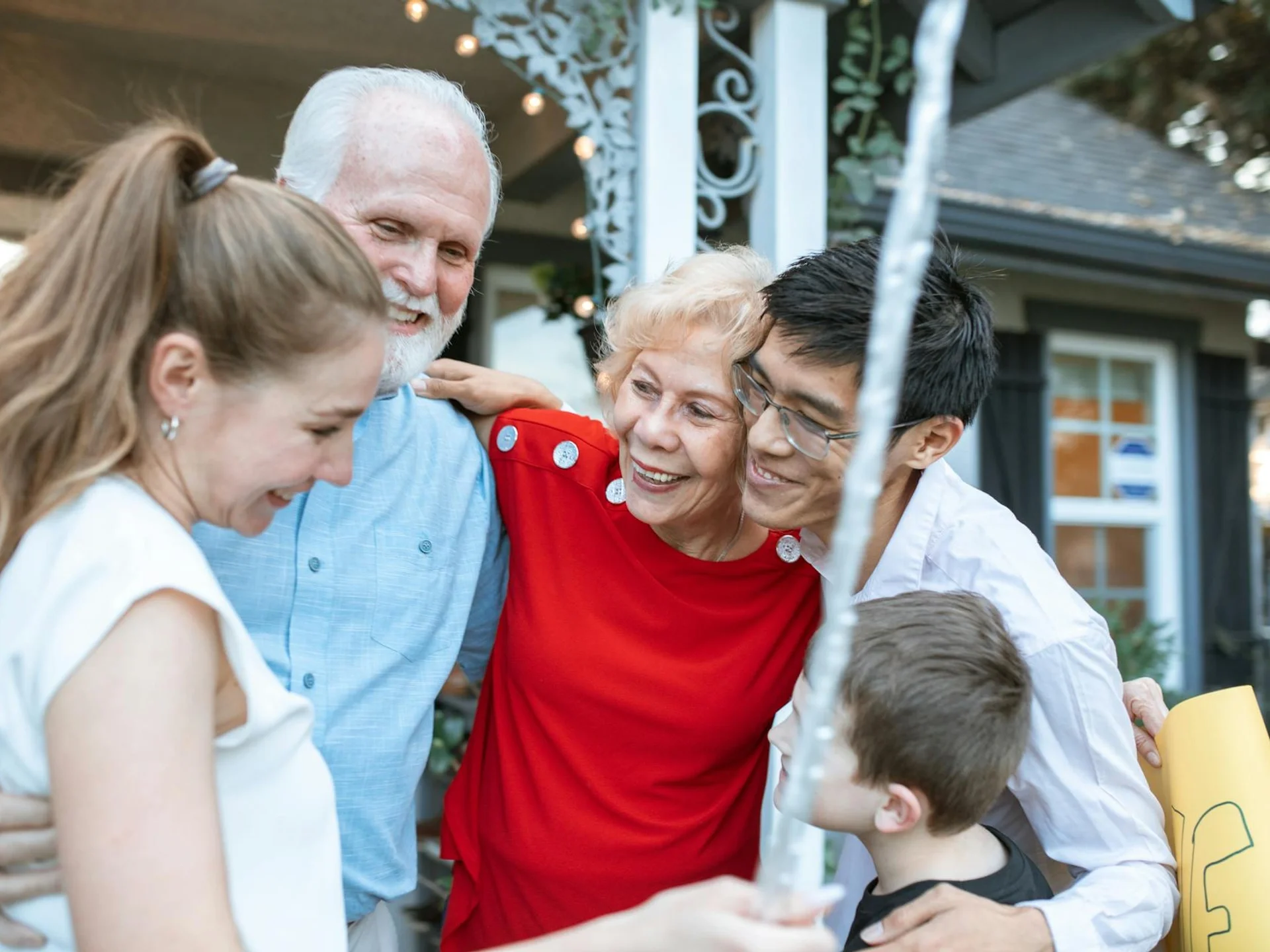 Joyful multigenerational family gathering, embracing each other outdoors