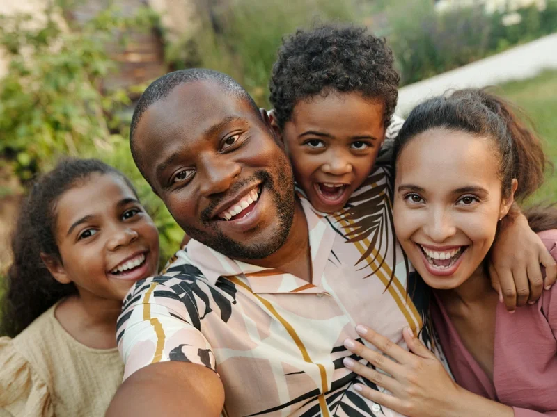 Joyful multicultural family together in a sunlit garden