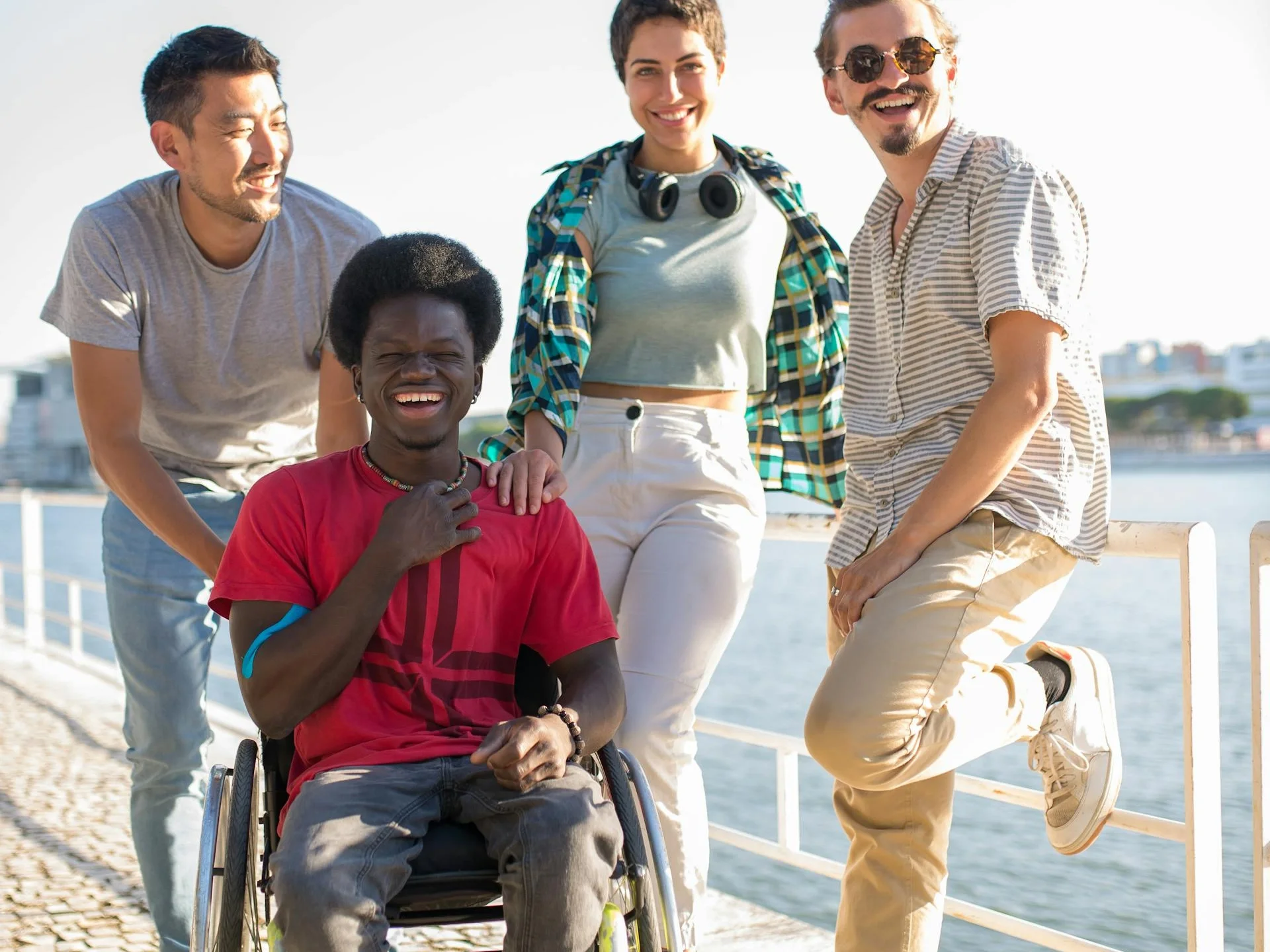 Diverse group of young friends sharing laughter by the riverside