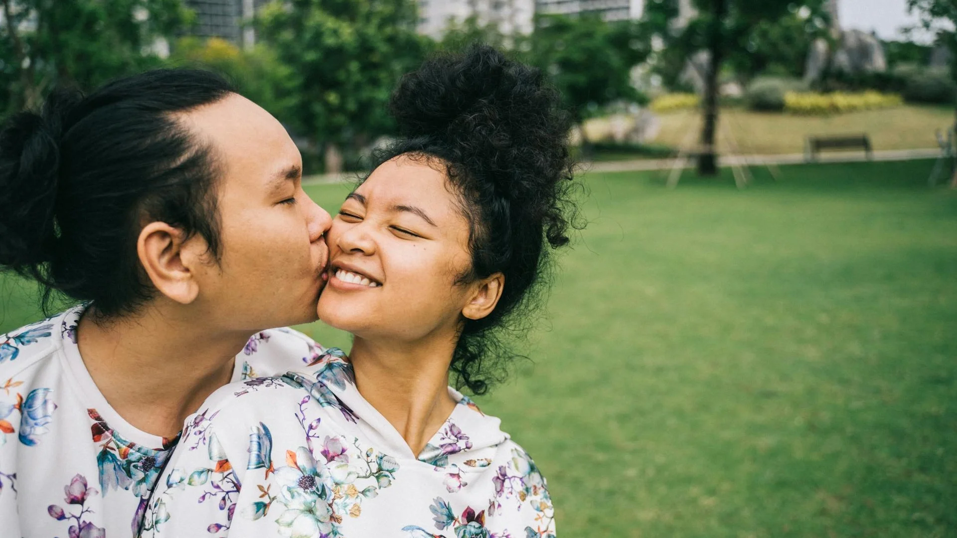 Happy couple sharing a loving moment in a scenic park landscape